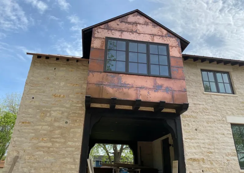 Copper metal panel facade on a stone building for Roof Repair in Park City